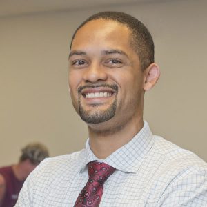 Raymond Kowalczyk, accounting instructor, smiling at the camera