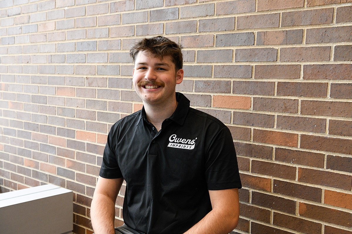 Carter Owens sitting at the atrium of the ICC East Peoria campus